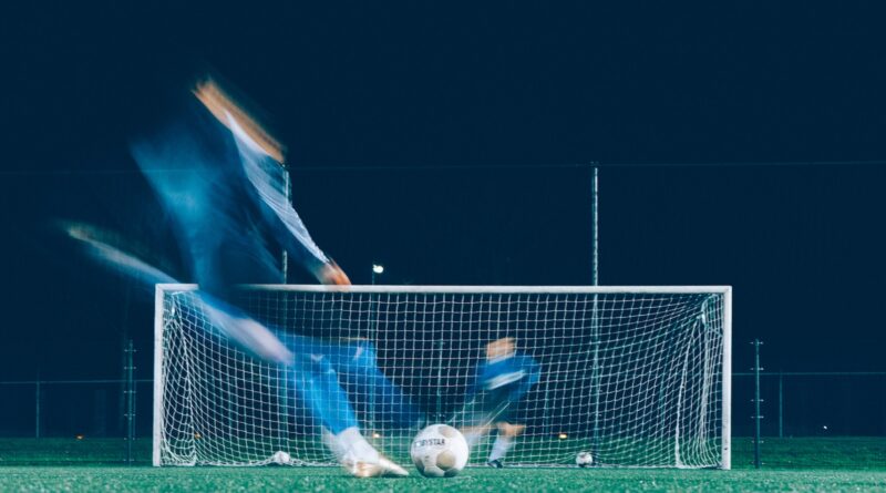 timelapse photo of soccer player kicking ball
